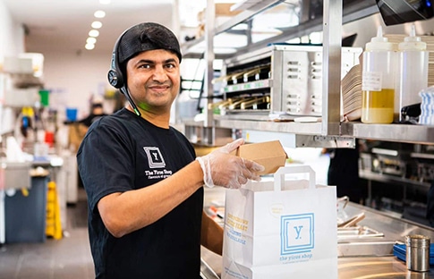 Employee Packing Food For Take Out — The Yiros Shop in Fortitude Valley, QLD
